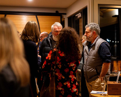 Group of people socialising at a cocktail event at Bangor Vineyard Shed.