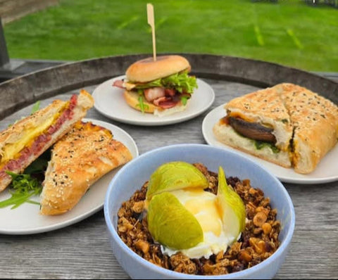 Breakfast dishes including a burger, sandwich, and bowl of food on a table with 'Breakfast at Bangor' text.