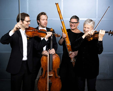 Four musicians from the Tasmanian Symphony Orchestra playing string instruments against a plain background
