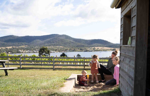 Children playing in the Bangor sandpit next to the cubby house. Family friendly vineyard with a cubby house, sandpit and large fenced lawn area.