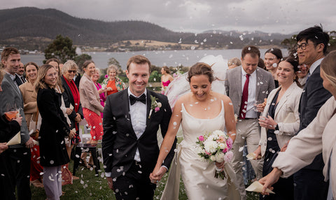 Wedding couple walking together with guests at Bangor Vineyard