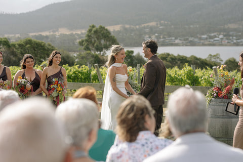 Wedding ceremony outdoors at Bangor Vineyard with guests and the couple.
