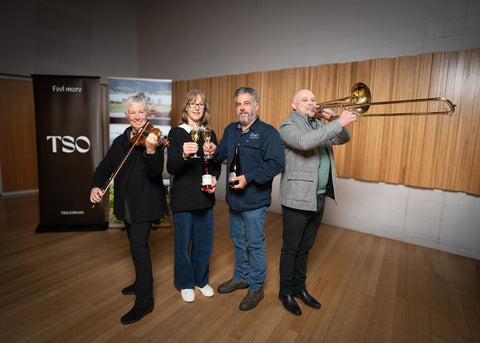 Matt and Vanessa Dunbabin from Bangor with TSO musicians Jenny Owen holding a violin and David Robins holding a Trombone.